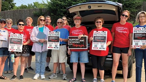 Nebraska members holding up signs - Support Our Schools and Sign the Petition