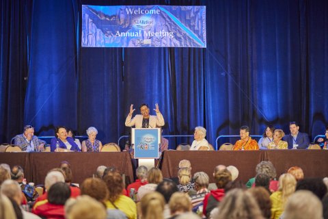 NEA President Becky Pringle at a podium speaking to the 2023 NEA-Retired Annual Meeting. 